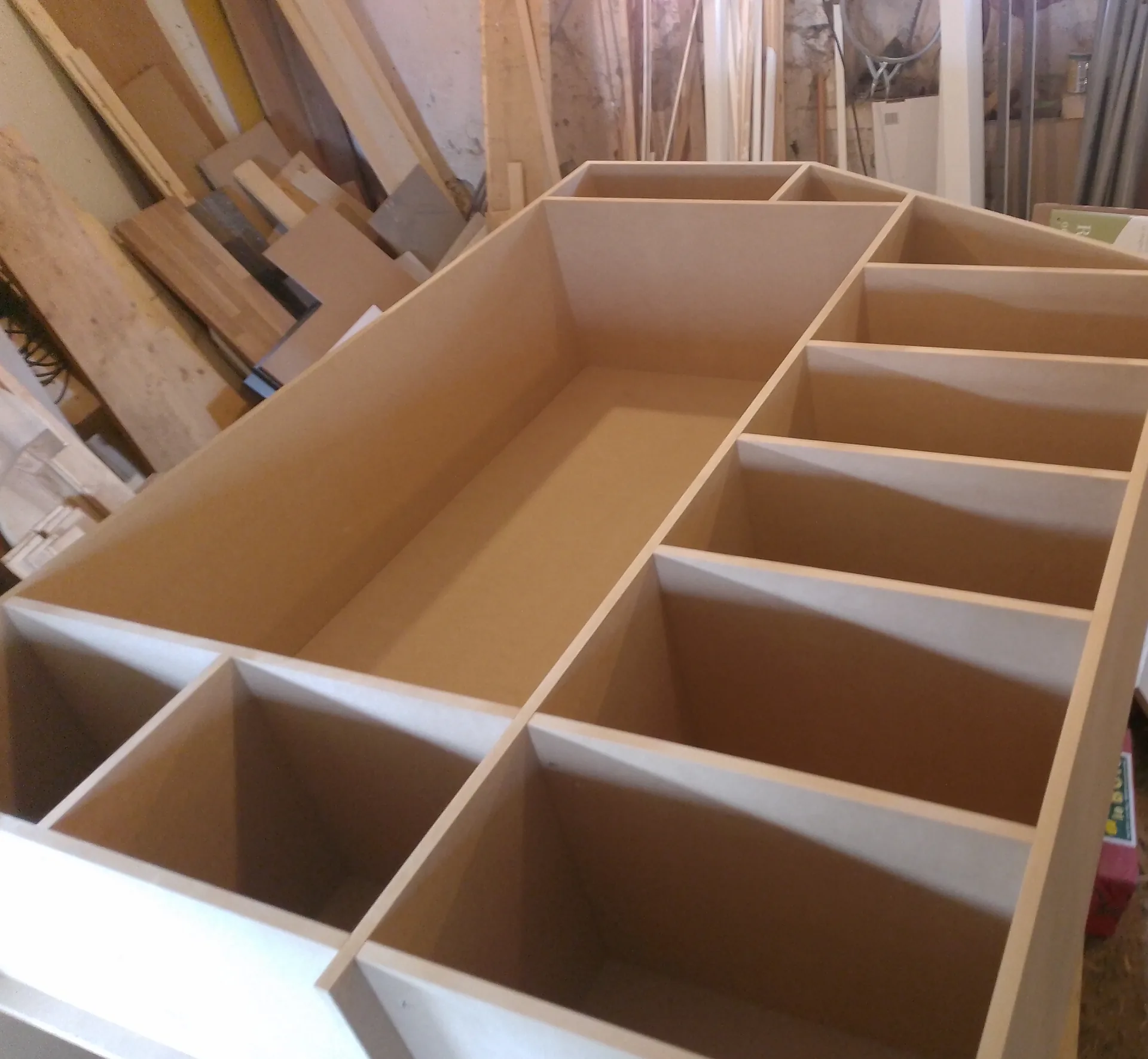 Carcass of the wardrobe in MDF, cut to the slope, on the workshop bench