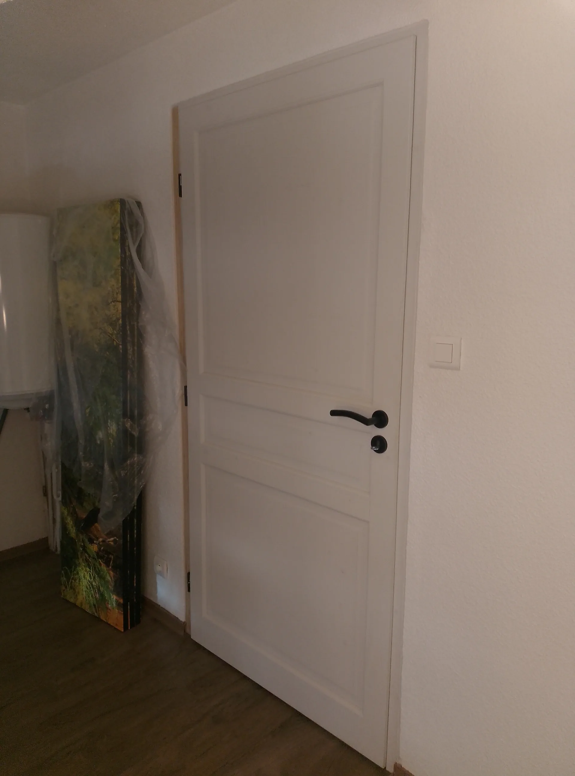 Bespoke internal door painted white, separating two spaces of the loft floor