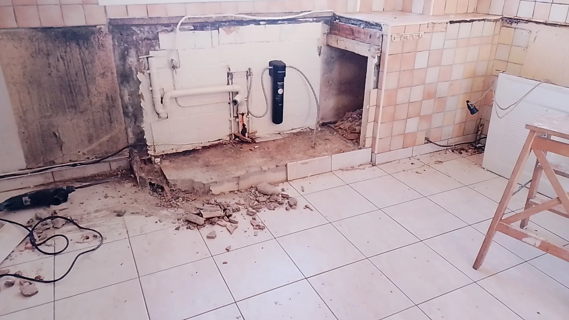 The demolition: walls stripped bare and the old wiring and pipework exposed