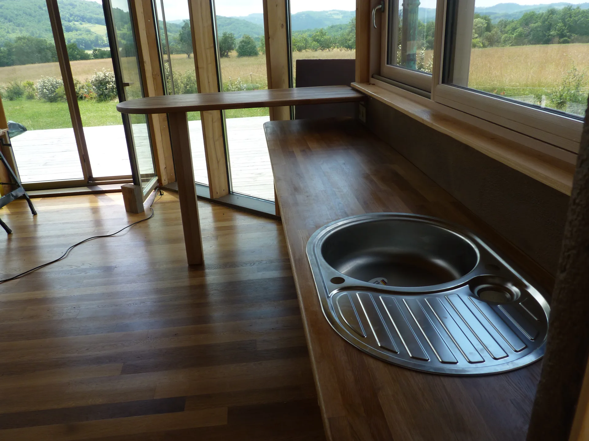 The solid oak worktop with its inset sink, in front of the patio doors