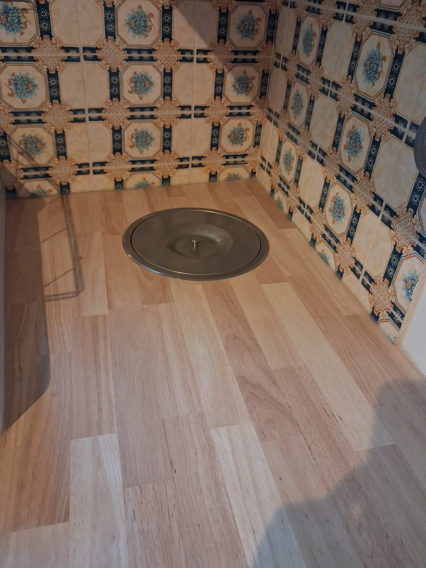 Compost bin recessed flush into the hevea worktop, with a round metal lid