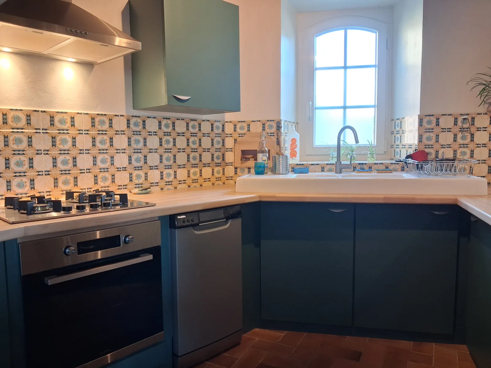 The finished kitchen: painted fronts, hevea worktop, sink and wall tiles kept