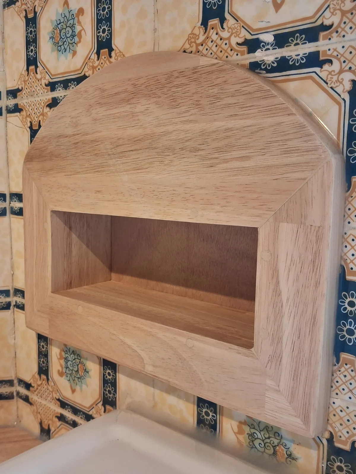 The niche lined with solid hevea above the sink, finished