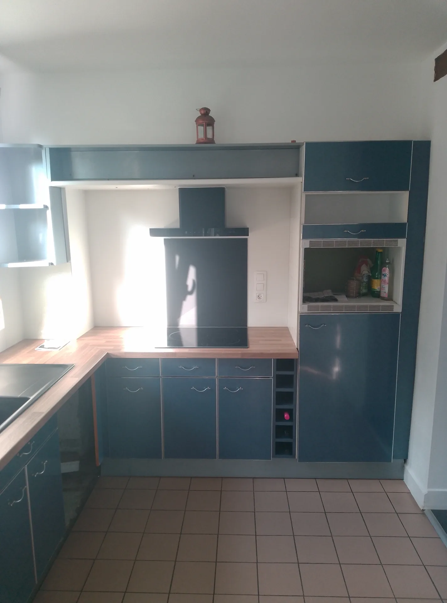 After: the new hood and its splashback, above the oak-effect worktop