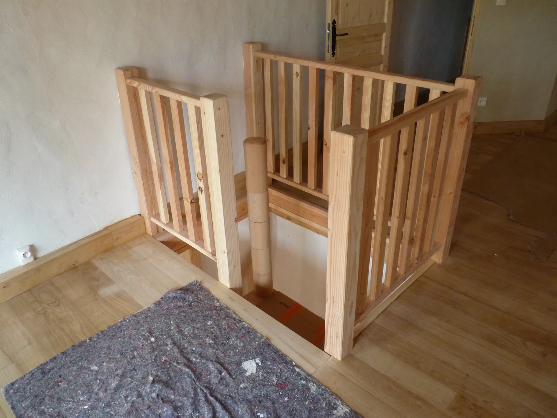 The simple-baluster railing fitted around the stairwell opening