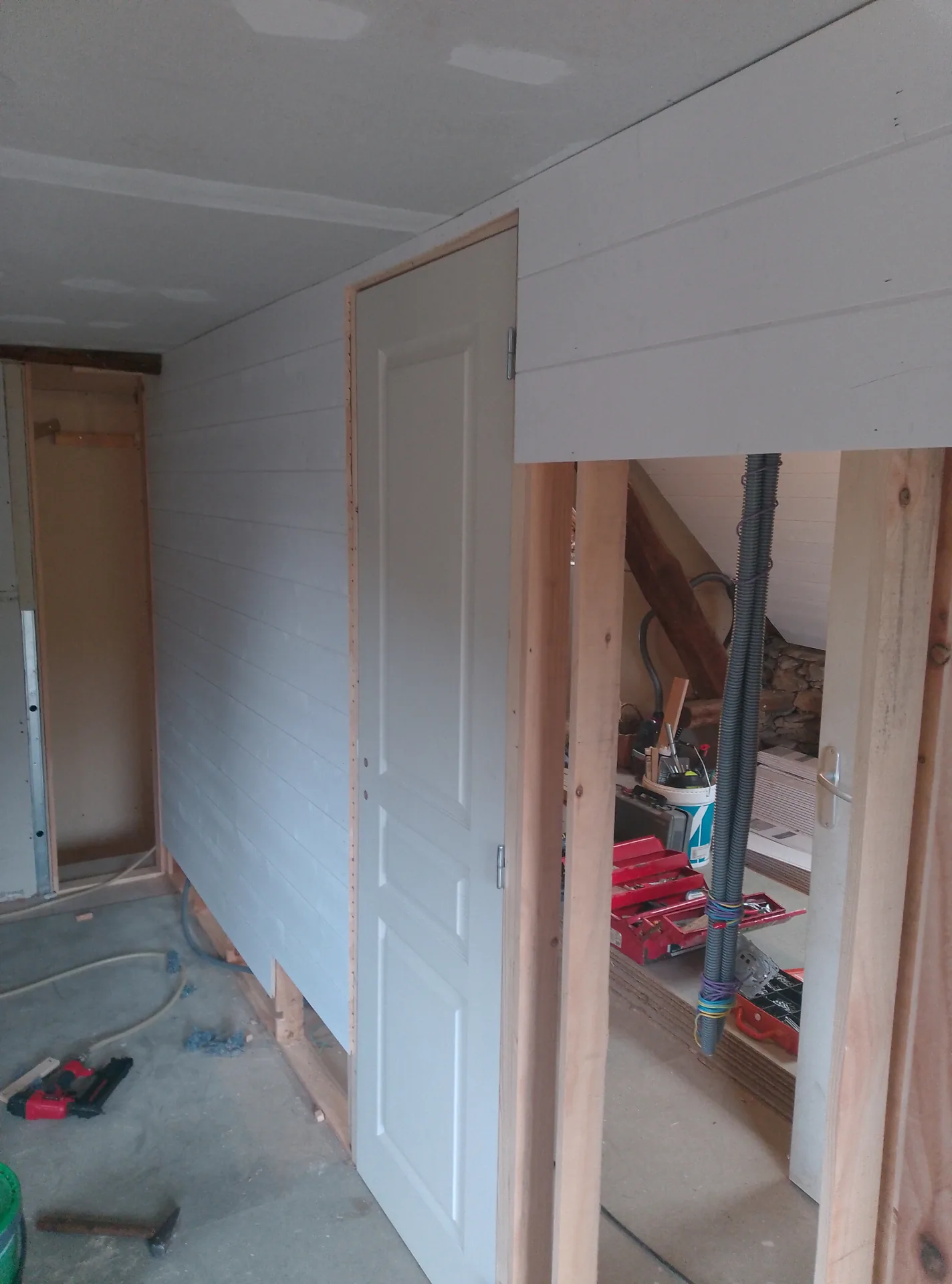 A partition in white panelling with its internal door fitted