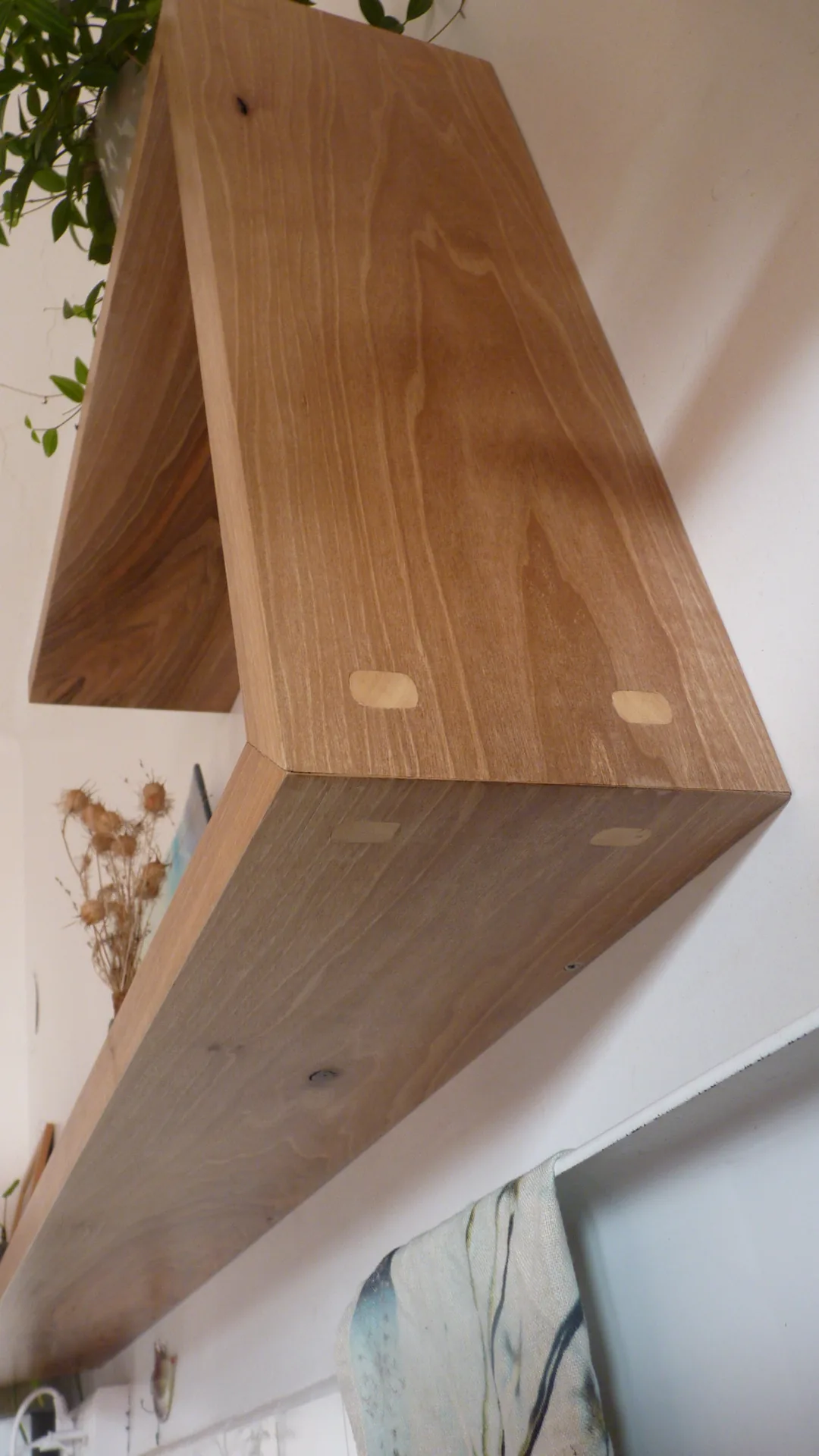 The 45° joint seen from below: the hornbeam loose tenons, very pale against the brown walnut