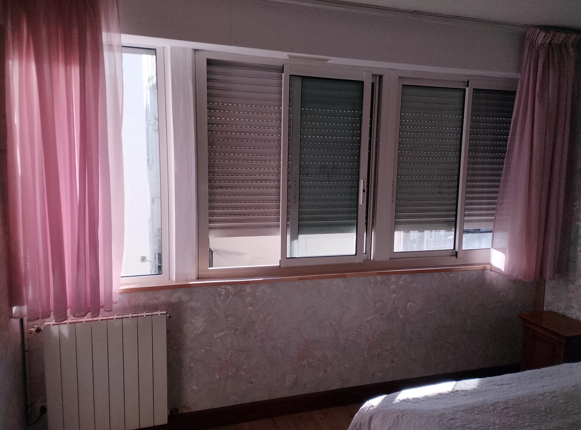 Before the work: the bedroom's old aluminium sliding windows