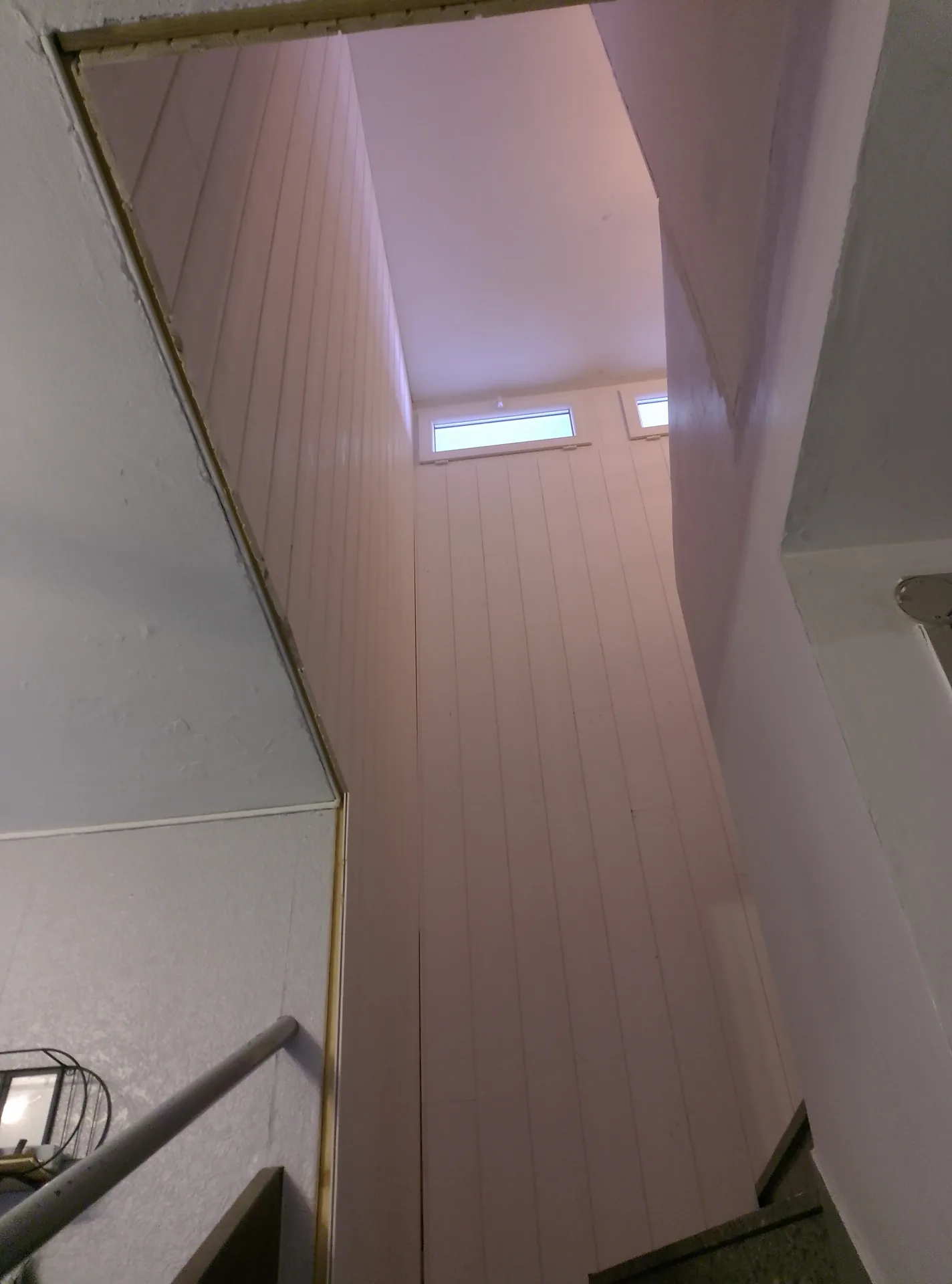 The polar white panelling fitted over the full height of the stairwell
