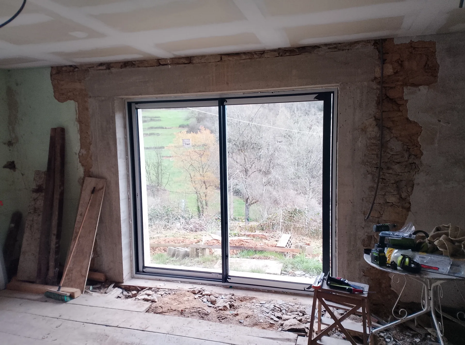The anthracite aluminium sliding patio door, seen from inside looking over the valley