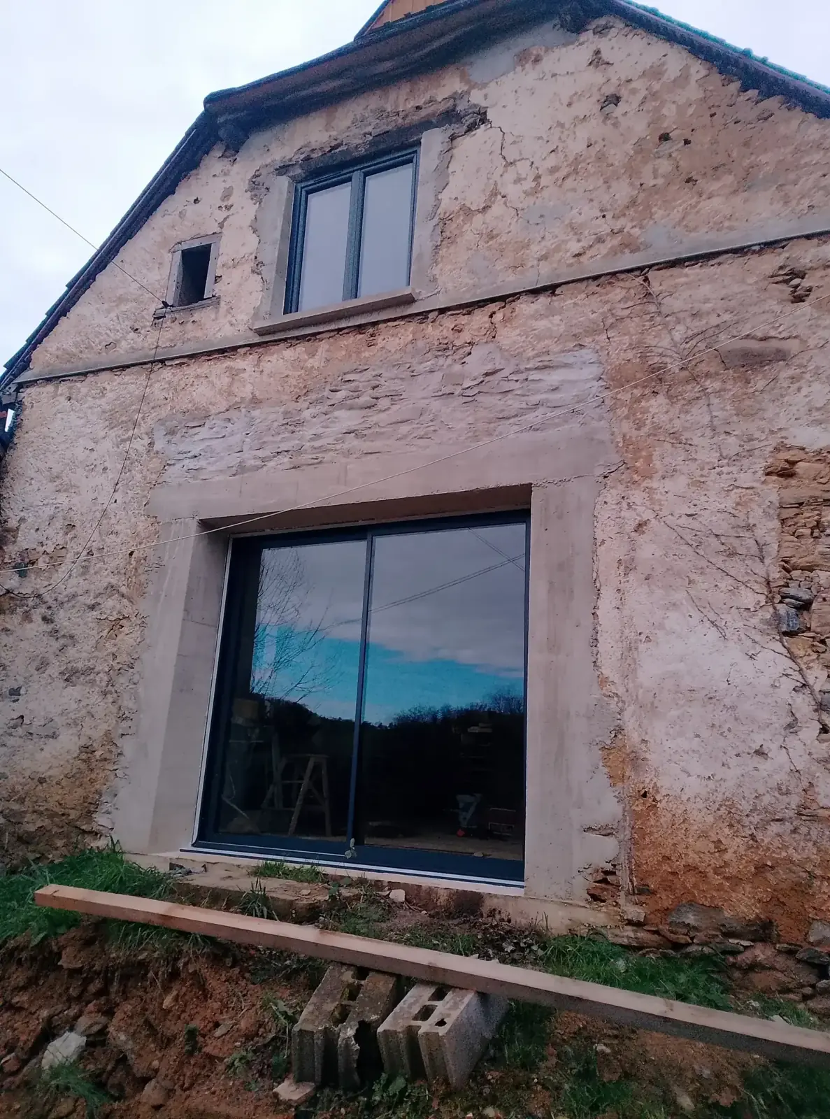The gable end with the patio door and the upstairs window replaced