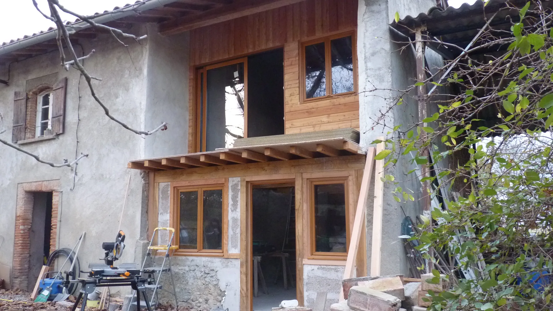 The restored façade: new timber cladding and joinery in keeping with the old farmhouse