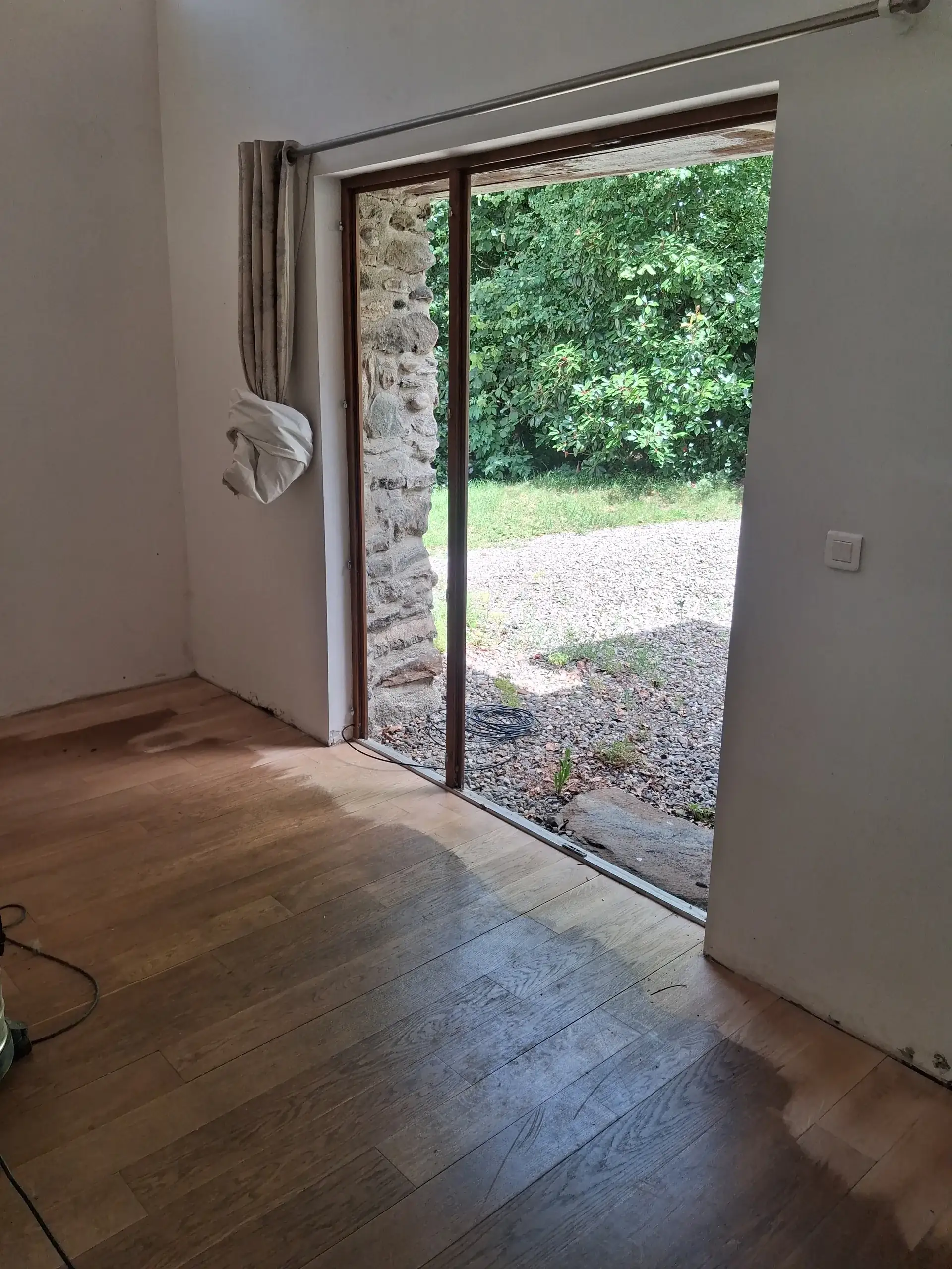 Before: the patio door and the damaged floor, mid-sanding