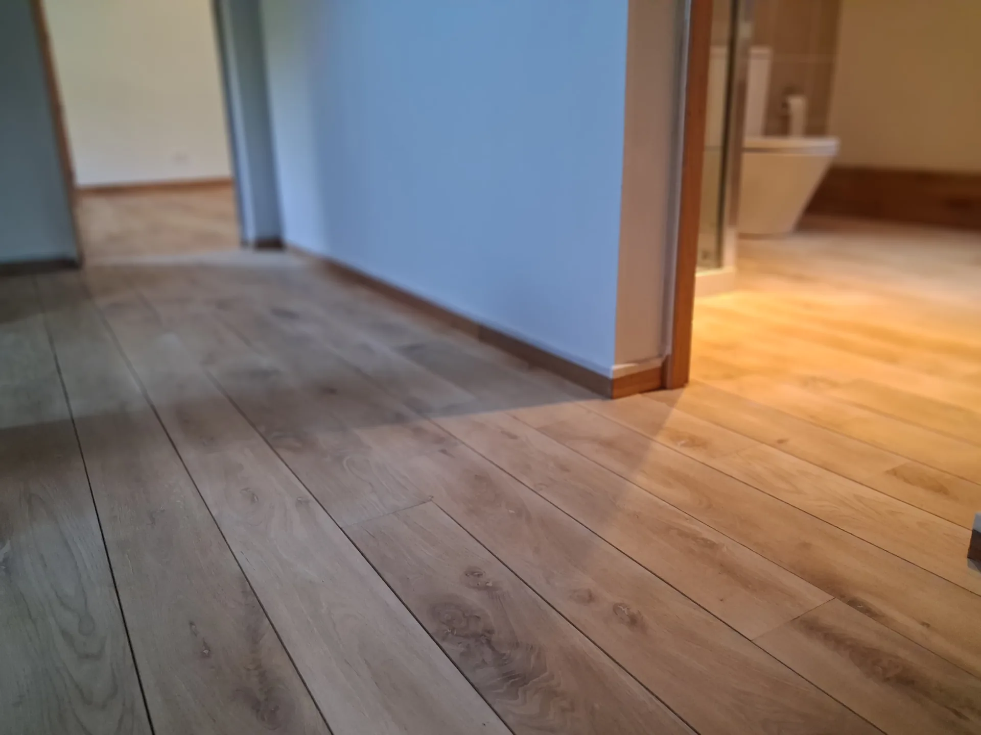 The restored oak floor upstairs, seen through the rooms, in Campan