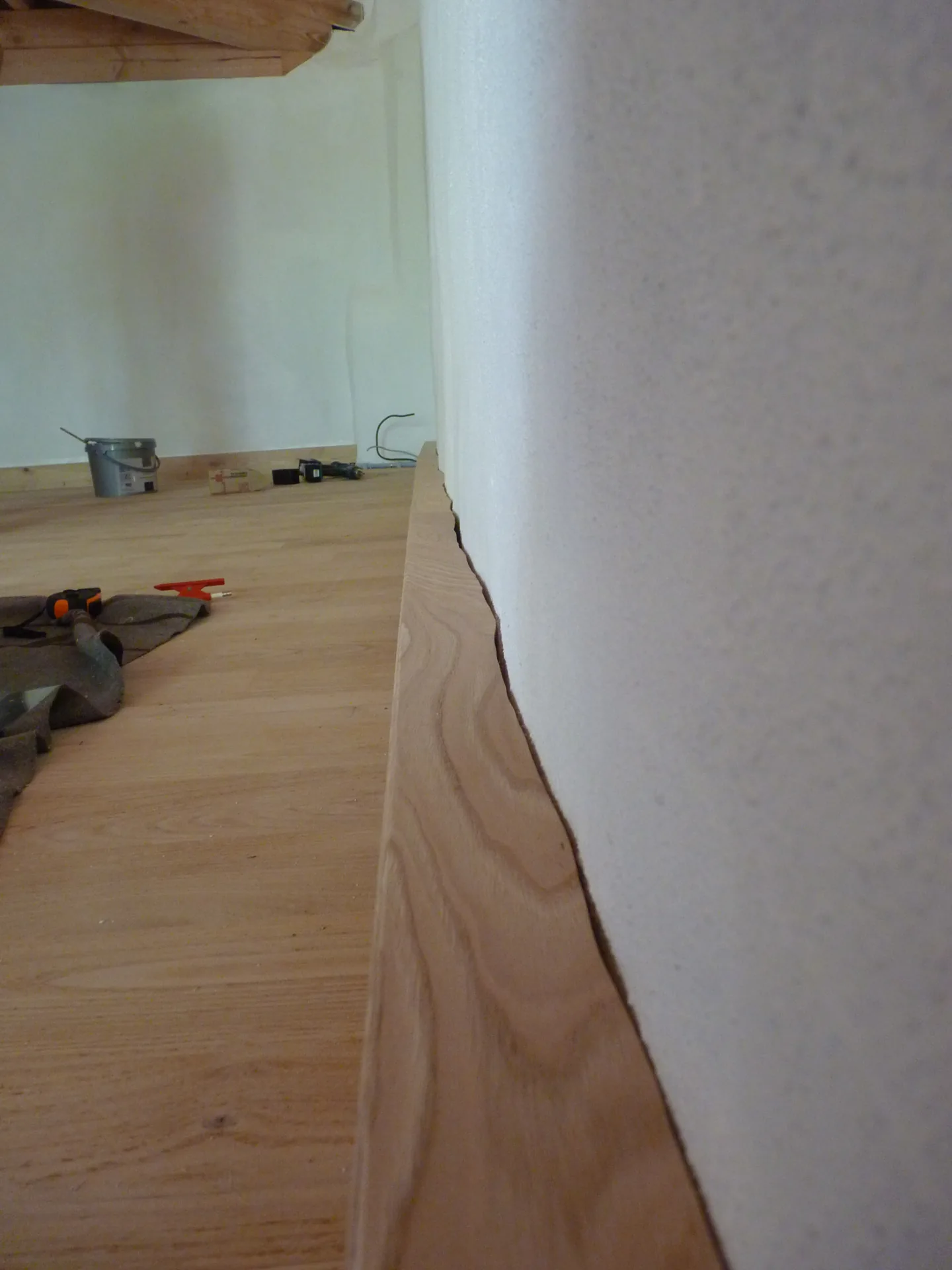 The edge of the hollow skirting cut to hug the exact relief of the wall