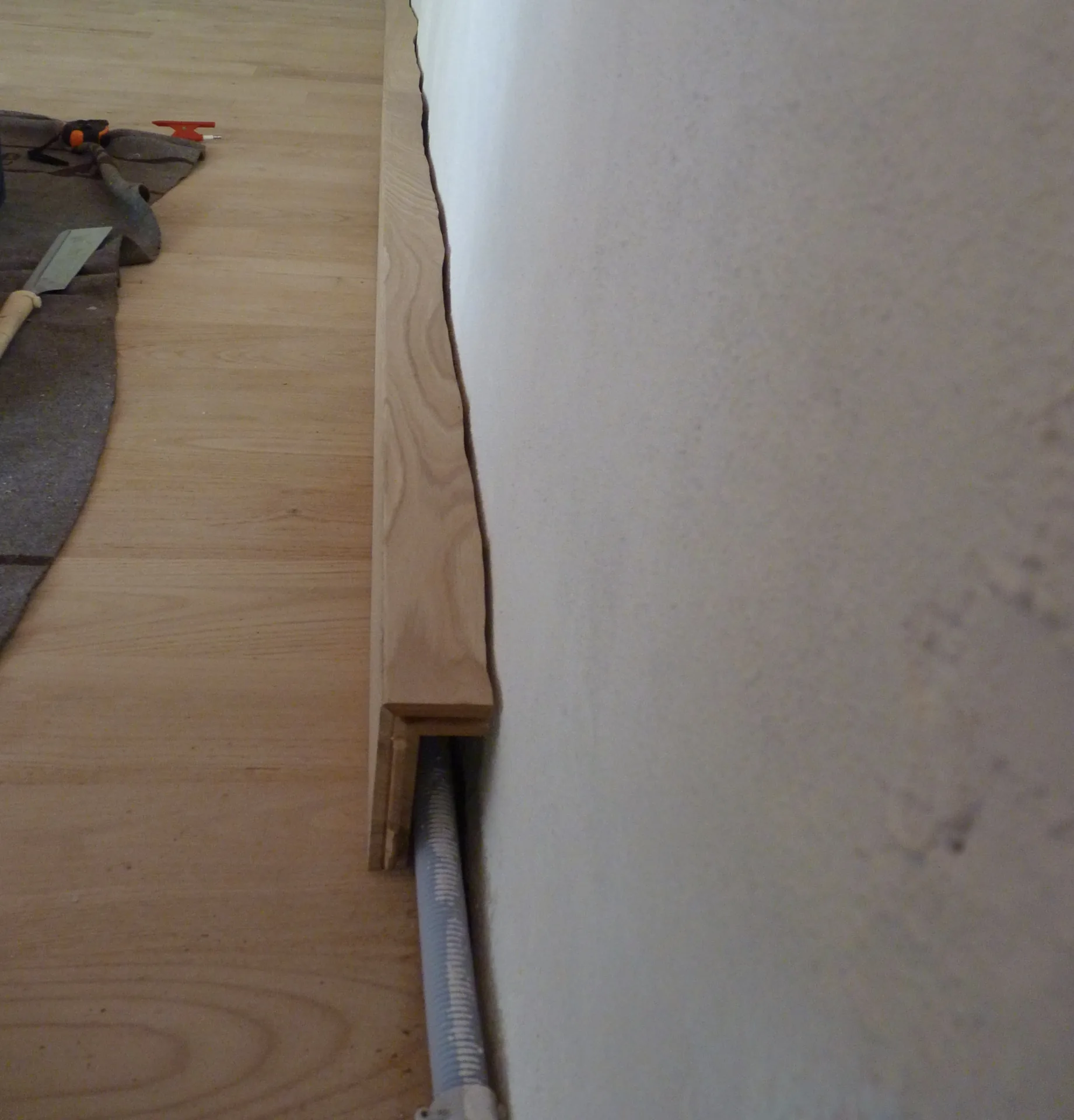 The skirting box open: the duct runs inside, invisible once closed
