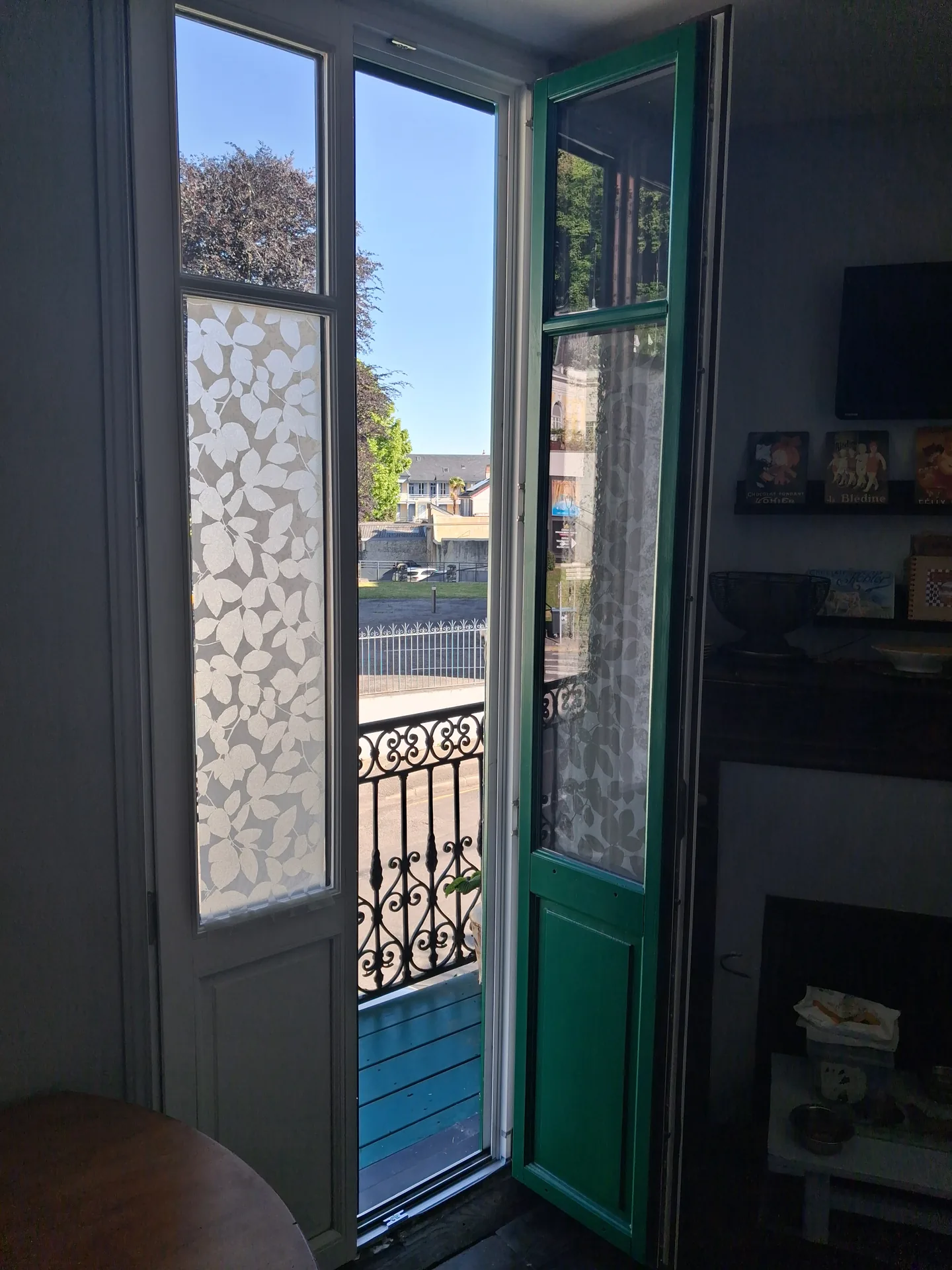 The new French doors open onto the balcony, white inside and green outside