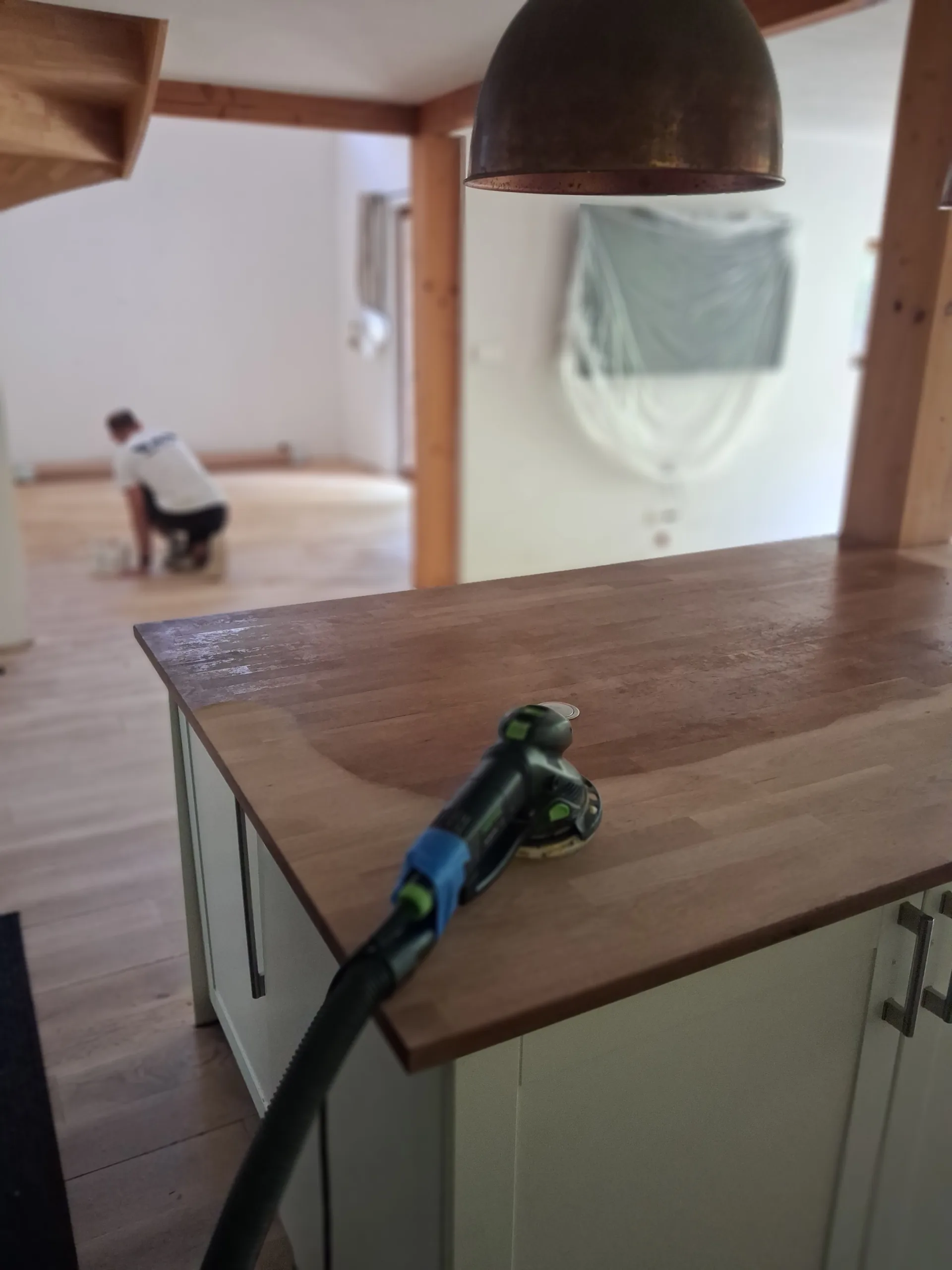 Sanding the central island worktop, orbital sander with dust extraction