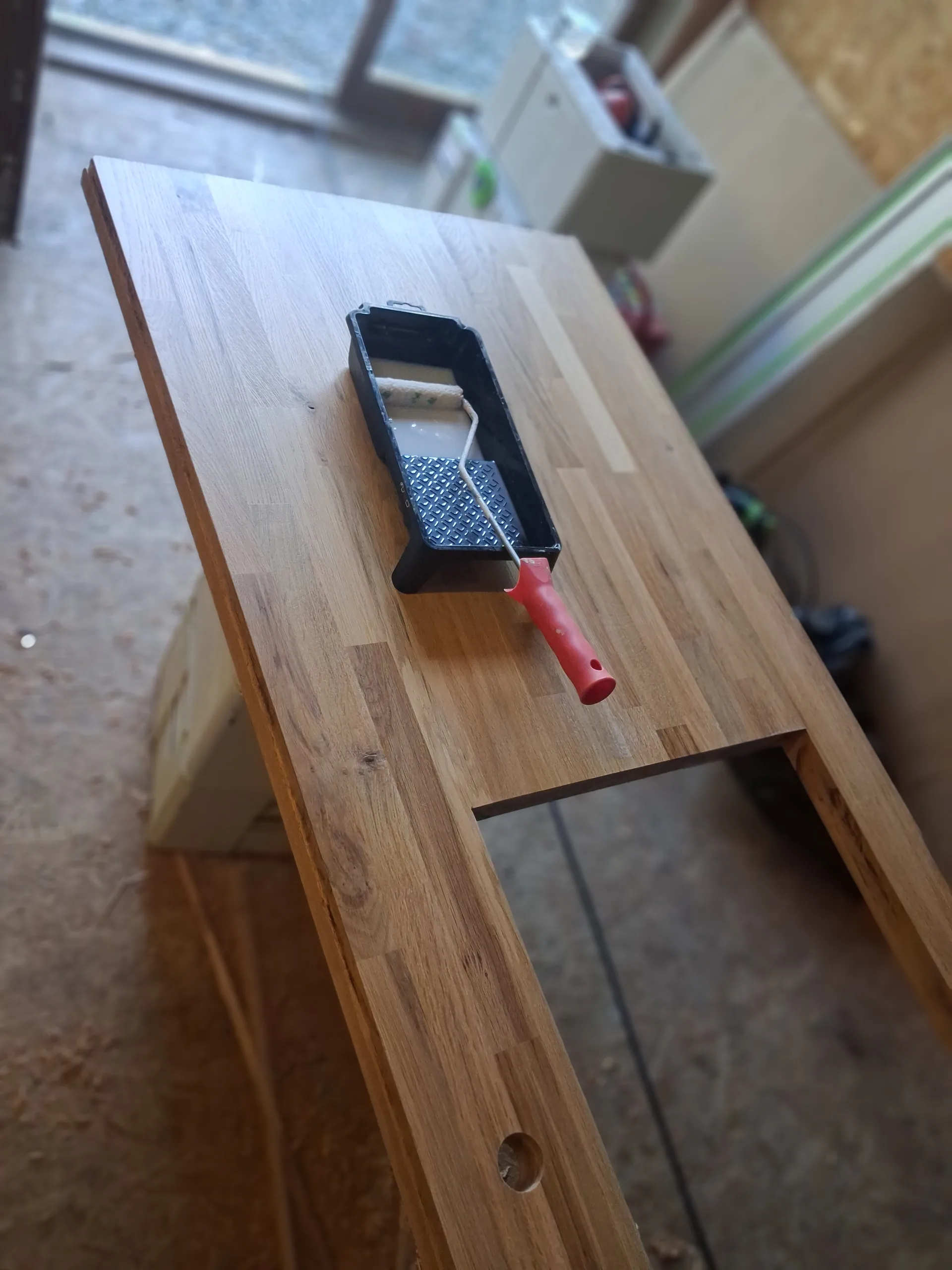 Varnishing the new worktop in the workshop, sink cut-out done