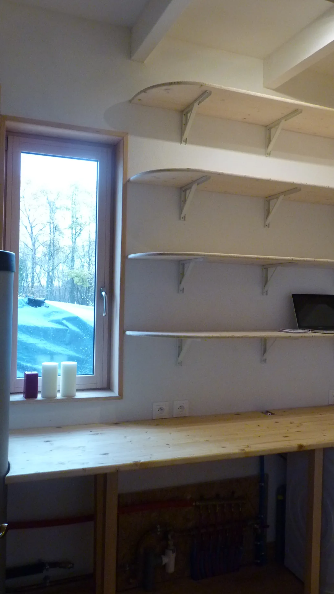 The desk corner of the utility room: thick solid spruce worktop and wall shelves